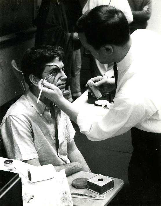 Richard Gregory applying stage makeup to Rogelio Novey