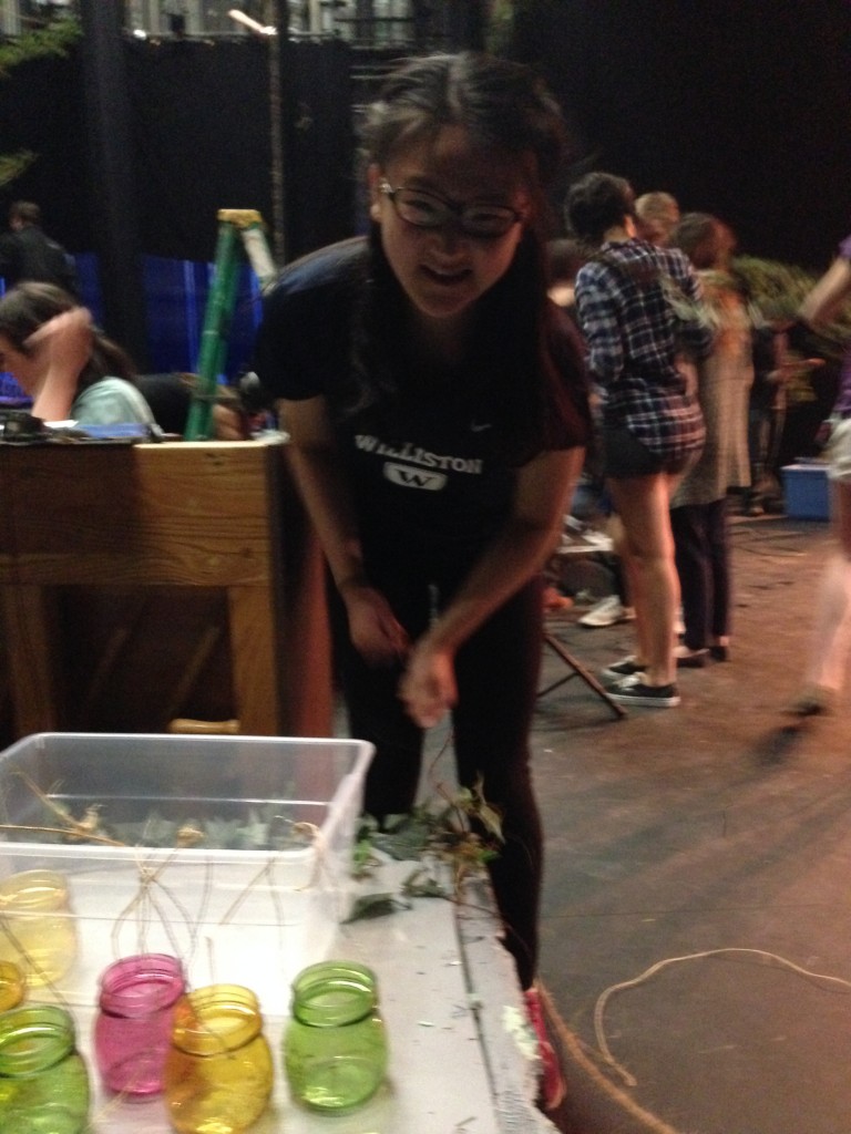 Tina Zhang '15 looks cheerful as she takes on the painstaking task of removing staples from the wooden platforms. 