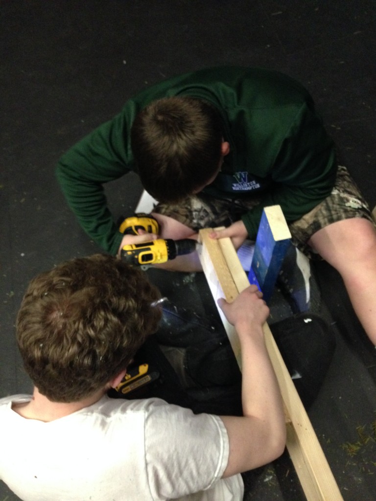 Josh Holmberg '18 and Henning Fischel '17 take apart the last legs that belonged to the rock wall. 