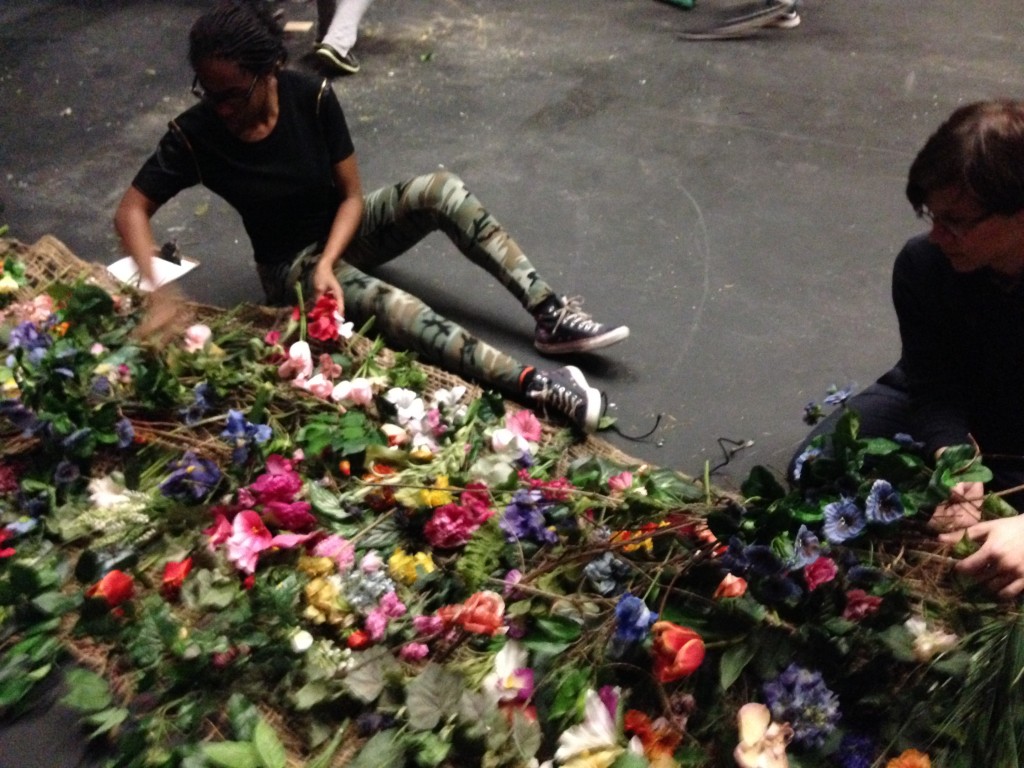 Destiny Nwafor '17 and Noah Jackson' 15work on preserving the flower arch used in the production. 
