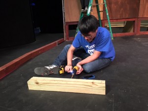 Stage Manager Khanh Pham works on a particularly stubborn piece of wood. Eventually he got it out! 