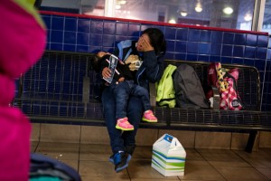 SAN ANTONIO, TEXAS - M.P., 21, waits with her 2 year old daughter at the San Antonio Greyhound Bus Station for a bus to Houston where she has family. November 10, 2015: Asylum-seeking women, most of them with children, have been bussed to San Antonio's central bus station from Dilley Residential Center or Karnes County Residential Center. Organizations including the Interfaith Welcome Coalition and the Red Cross greet the majority of women at the Greyhound Bus Station and assist the women in traveling on or offer temporary shelter in San Antonio. From here, many will transport to family members throughout the country. Others will go to Raices House, a shelter in San Antonio, where they will be assisted. Most women are forced to wear electronic ankle monitors. Ilana Panich-Linsman for The New York Times