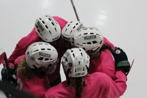 Girls varsity hockey players during its pink in the rink game